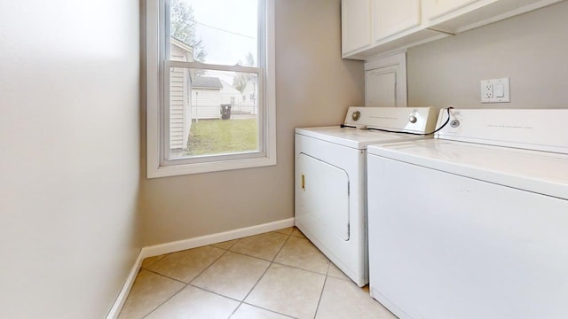 laundry room with cabinet space, separate washer and dryer, baseboards, and a healthy amount of sunlight