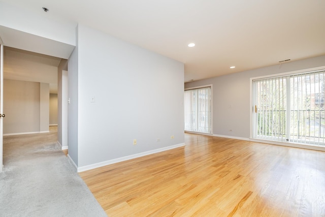 empty room featuring baseboards, recessed lighting, and light wood-style floors