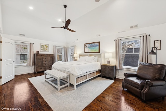 bedroom featuring visible vents, multiple windows, baseboards, and dark wood finished floors