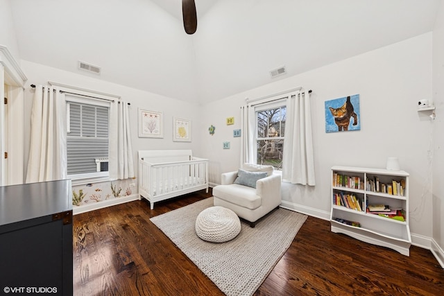 bedroom featuring baseboards, wood finished floors, and visible vents