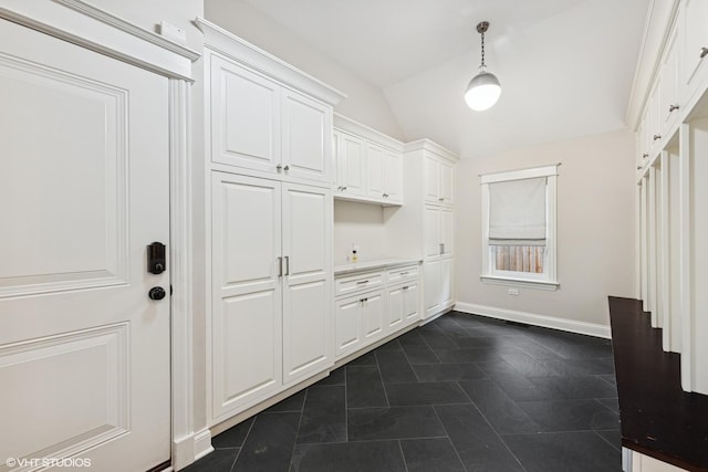 mudroom featuring vaulted ceiling and baseboards