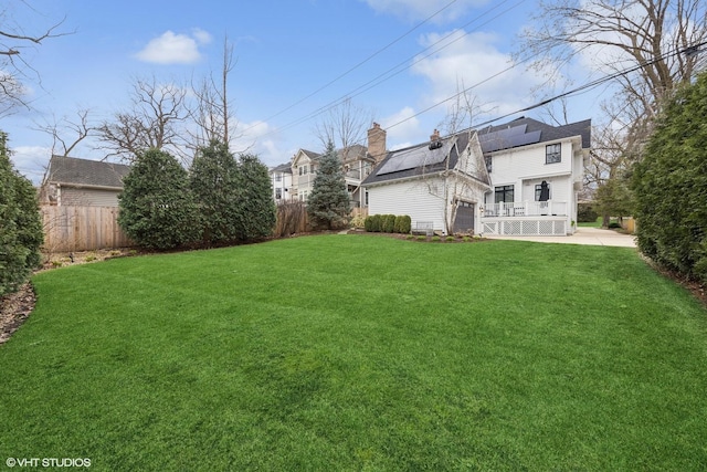 view of yard with an attached garage and fence