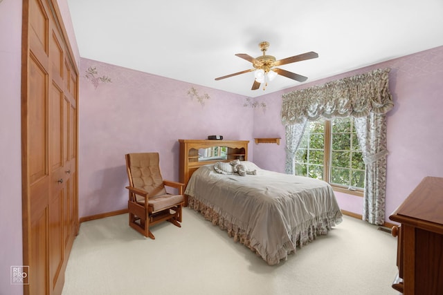 bedroom with baseboards, ceiling fan, and light colored carpet