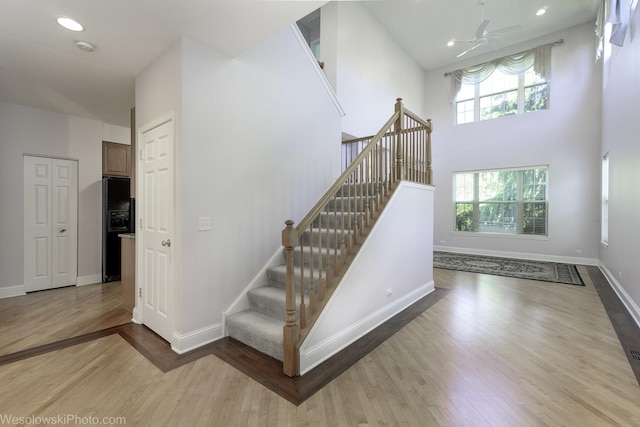 418 Bay Tree Cir, Vernon Hills, IL 60061 - staircase featuring wood finished floors, healthy amount of natural light, baseboards, a towering ceiling, and recessed lighting