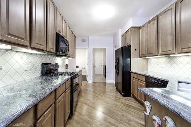 418 Bay Tree Cir, Vernon Hills, IL 60061 - kitchen with black appliances, light wood-type flooring, tasteful backsplash, and stone countertops
