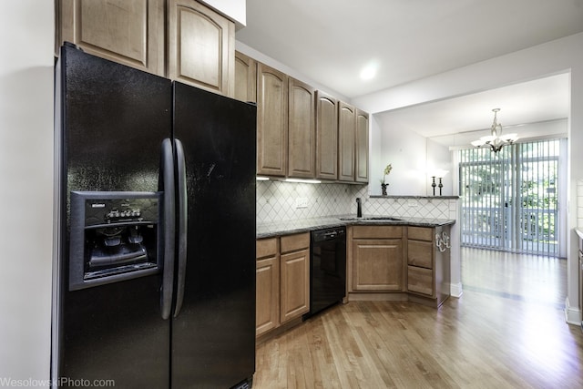 418 Bay Tree Cir, Vernon Hills, IL 60061 - kitchen featuring black appliances, a sink, light wood finished floors, backsplash, and a chandelier