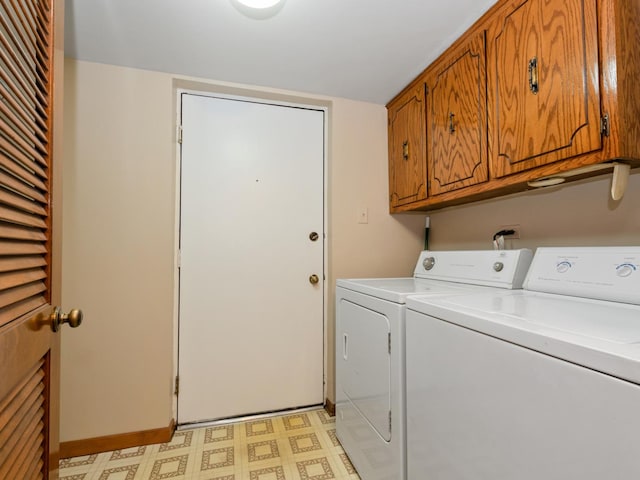 laundry room featuring washer and clothes dryer, cabinet space, and light flooring