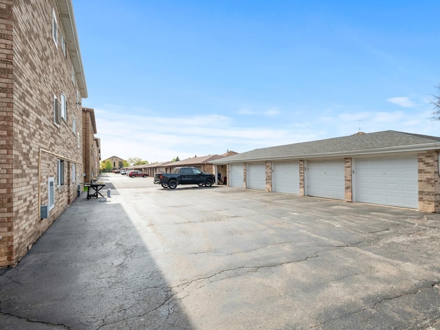view of parking with community garages