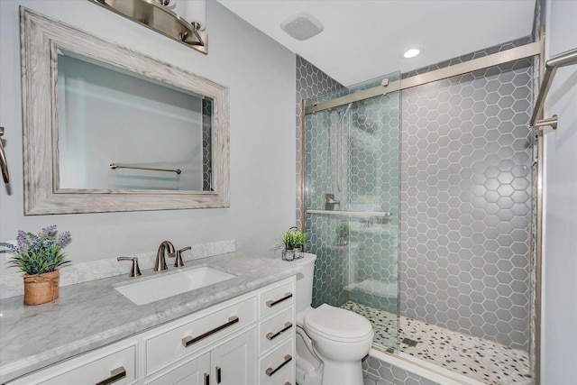 full bath with a shower stall, recessed lighting, vanity, and toilet