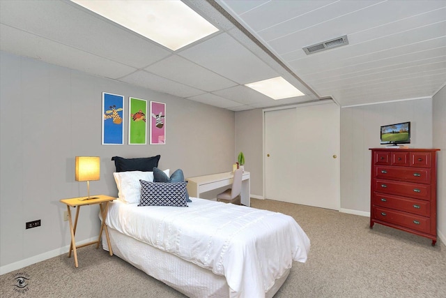 carpeted bedroom featuring visible vents, baseboards, and a closet