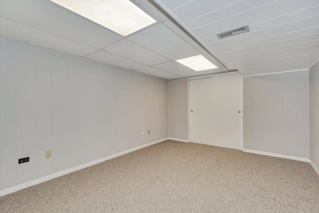 carpeted empty room with visible vents and baseboards
