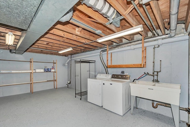 unfinished below grade area featuring a sink and washing machine and dryer
