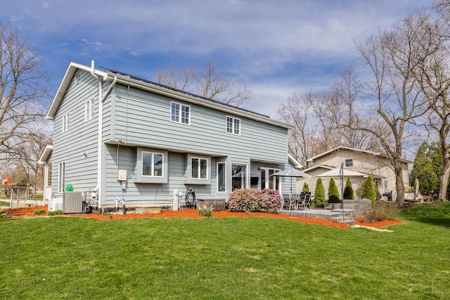 8001 William Dr, Willowbrook, IL 60527 - rear view of property with a patio, central air condition unit, and a yard
