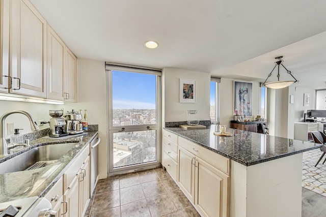 kitchen featuring light tile patterned flooring, a sink, dark stone countertops, a peninsula, and decorative light fixtures