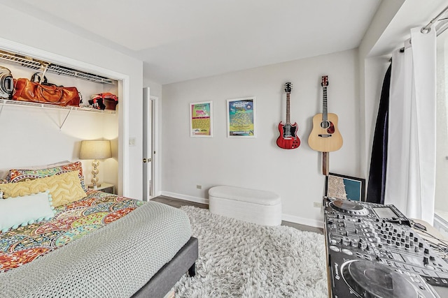 bedroom featuring baseboards and wood finished floors