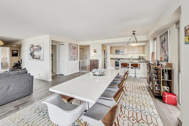 dining room with light wood-style floors and baseboards