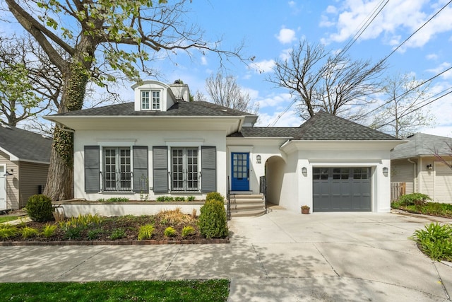 7968 Iowa St, River Forest, IL 60305 - view of front of home featuring concrete driveway, stucco siding, a shingled roof, and a garage
