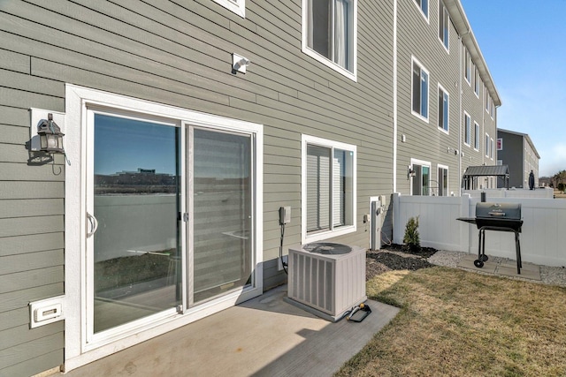 exterior space featuring cooling unit and fence