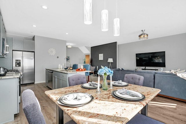 dining area with recessed lighting and light wood-style floors