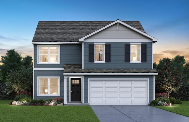 traditional-style house featuring a yard, a shingled roof, a garage, and concrete driveway