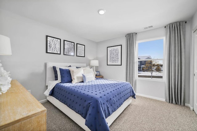 carpeted bedroom with visible vents and baseboards