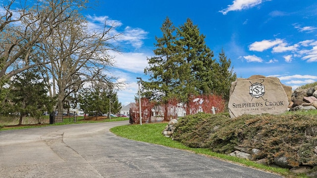 community / neighborhood sign with driveway