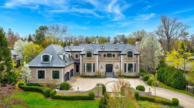 494 Sheridan Rd, Glencoe, IL 60022 - back of house with curved driveway, a balcony, a high end roof, and a chimney