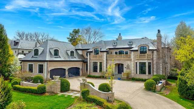 494 Sheridan Rd, Glencoe, IL 60022 - french country home featuring a chimney, a high end roof, a balcony, and driveway