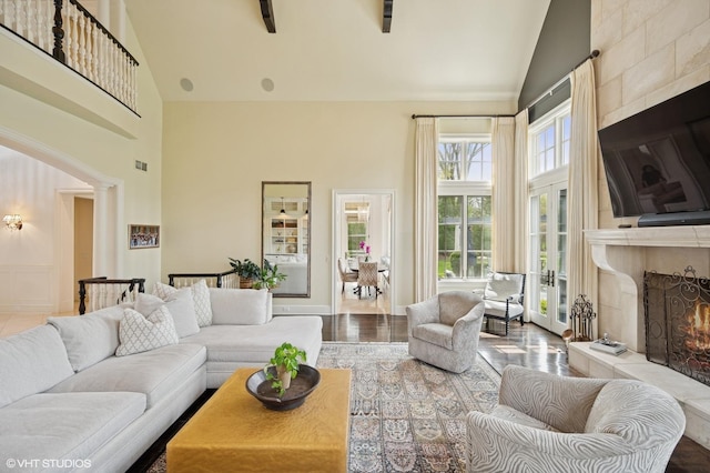 494 Sheridan Rd, Glencoe, IL 60022 - living room featuring visible vents, decorative columns, wood finished floors, high vaulted ceiling, and a large fireplace