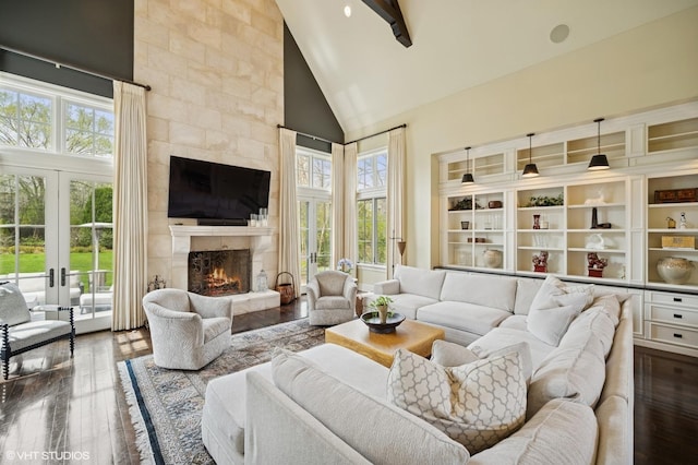 494 Sheridan Rd, Glencoe, IL 60022 - living room with high vaulted ceiling, a tiled fireplace, french doors, and dark wood-type flooring