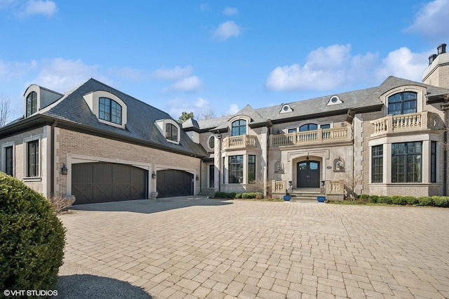 494 Sheridan Rd, Glencoe, IL 60022 - view of front facade with a garage, a balcony, a high end roof, decorative driveway, and brick siding