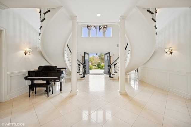 494 Sheridan Rd, Glencoe, IL 60022 - entryway featuring an inviting chandelier, stairs, ornate columns, and a decorative wall