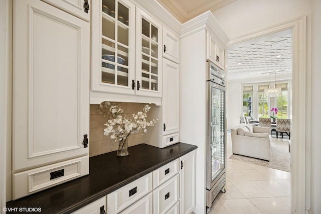 494 Sheridan Rd, Glencoe, IL 60022 - bar featuring decorative backsplash, crown molding, refrigerator, light tile patterned floors, and a chandelier