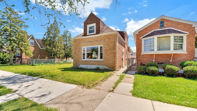 3843 W 56th St, Chicago, IL 60629 - bungalow with a front yard, brick siding, and fence