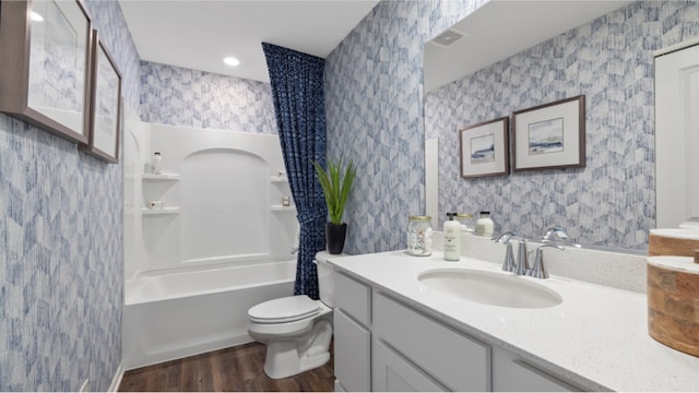 full bath with visible vents, toilet, vanity, wood finished floors, and wallpapered walls