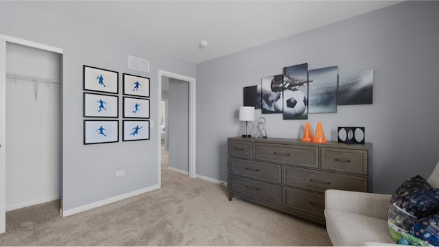 bedroom featuring visible vents, baseboards, a closet, and light colored carpet