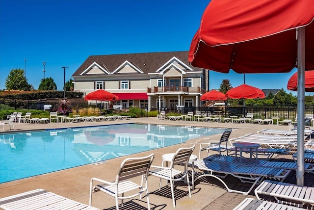 view of pool with a patio and fence