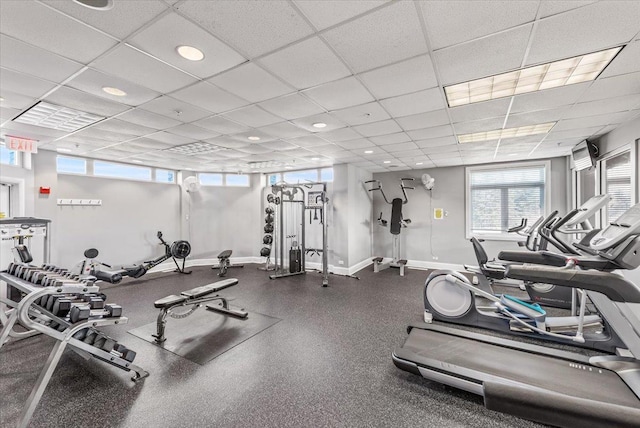 gym with recessed lighting, a paneled ceiling, and baseboards