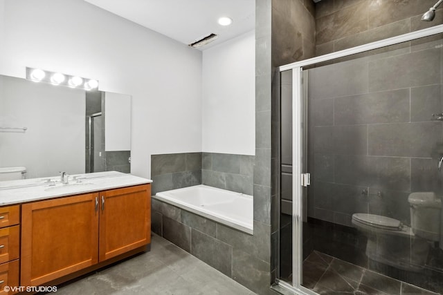 full bathroom featuring vanity, toilet, tile patterned floors, a bath, and a stall shower