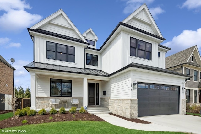 modern farmhouse style home featuring board and batten siding, stone siding, a standing seam roof, and covered porch
