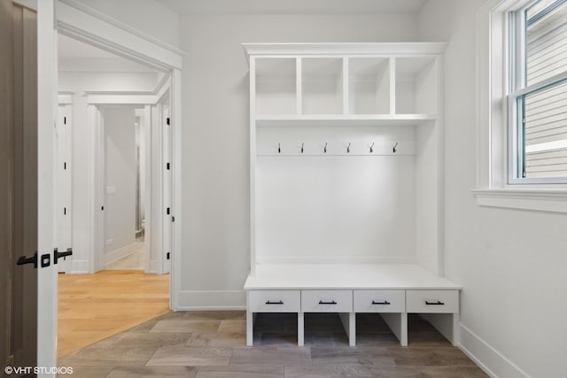 mudroom featuring baseboards and wood finished floors