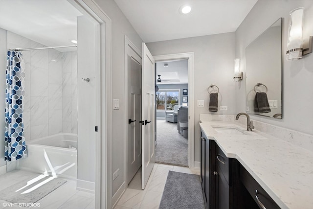 ensuite bathroom with recessed lighting, vanity, connected bathroom, shower / tub combo with curtain, and baseboards