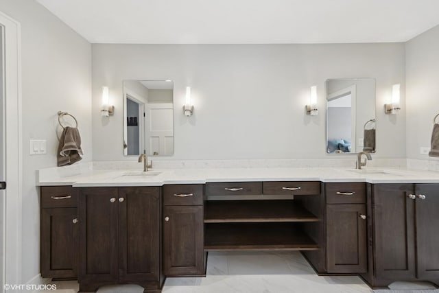 bathroom with marble finish floor and vanity
