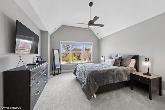bedroom with light carpet, vaulted ceiling, baseboards, and ceiling fan