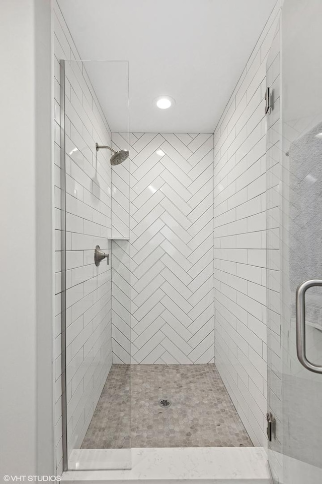 full bath with recessed lighting and a shower stall