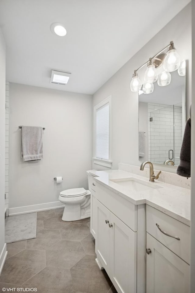 bathroom with baseboards, a shower stall, toilet, and vanity