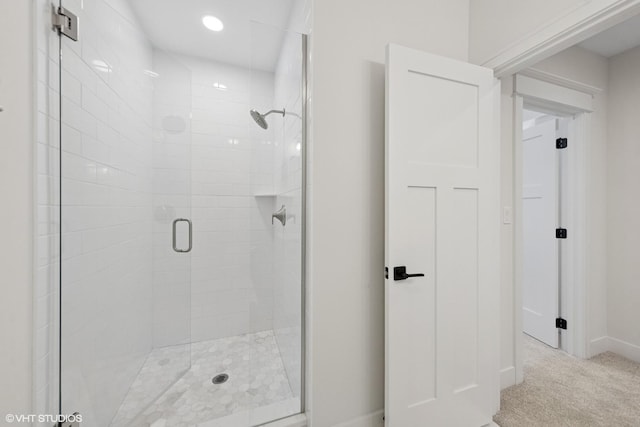bathroom with baseboards and a stall shower