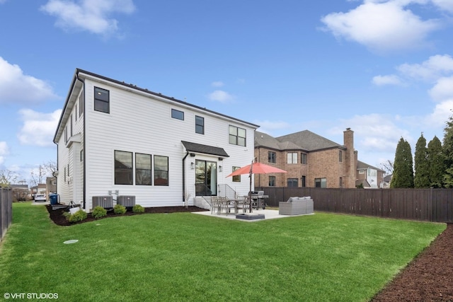 rear view of house with a patio area, a lawn, a fenced backyard, and central AC unit