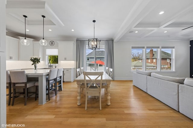 dining area featuring recessed lighting, light wood finished floors, an inviting chandelier, coffered ceiling, and beam ceiling