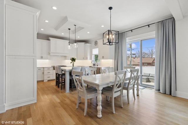 dining space with recessed lighting, a notable chandelier, and light wood-style flooring